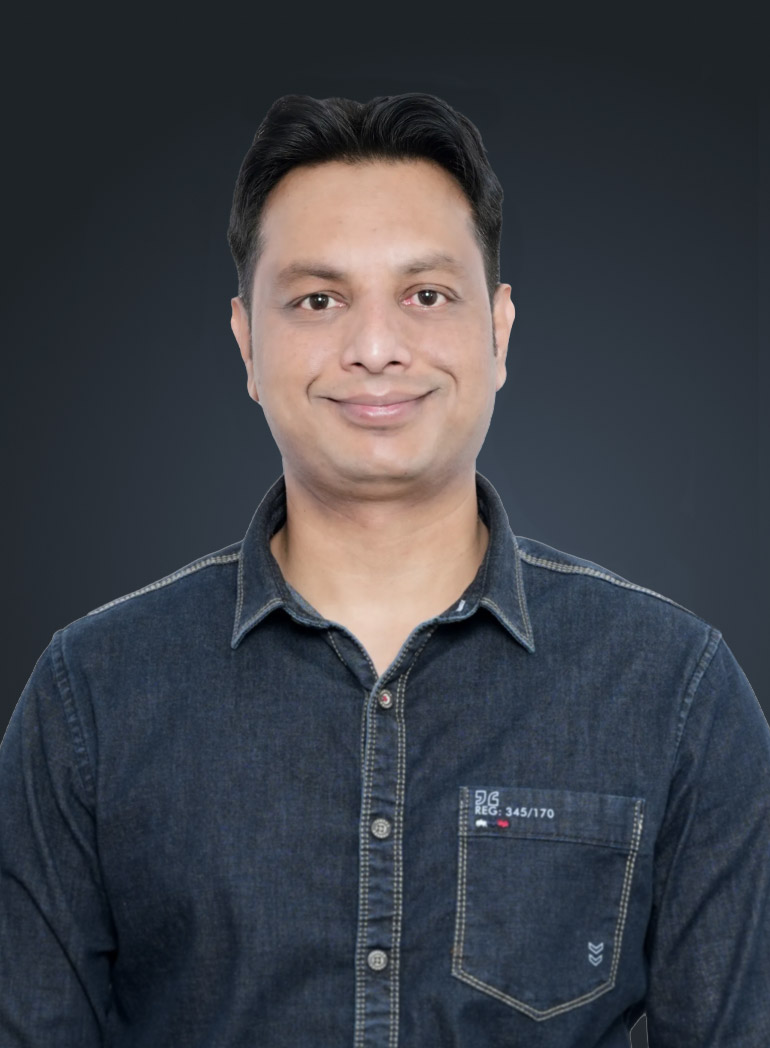 Professional man in denim shirt against dark background, representing web design and digital services expertise.